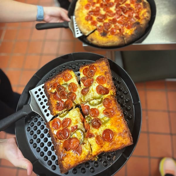 Two pizzas, one round and one square with pepperoni and jalapeños, on pizza pans.