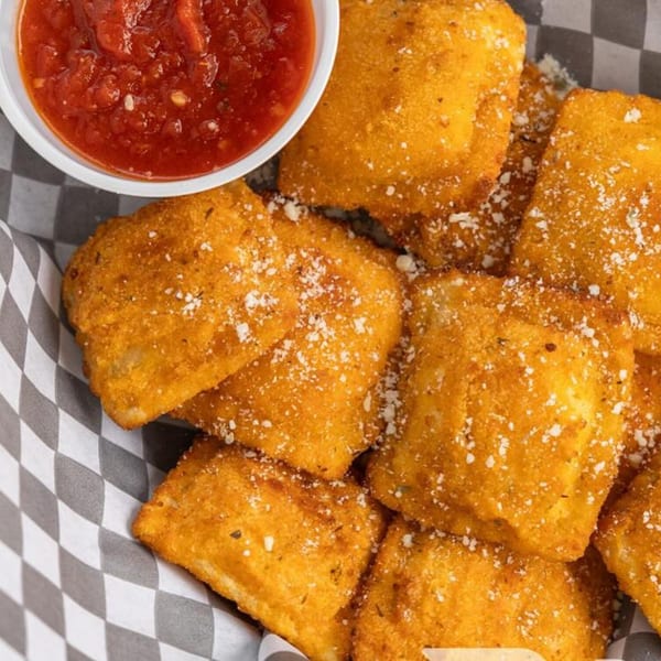Golden fried ravioli dusted with Parmesan cheese, served with a side of marinara sauce.